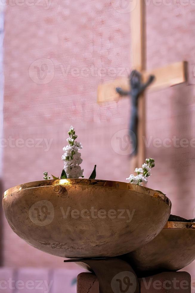 baptismal font with flowers in the church photo