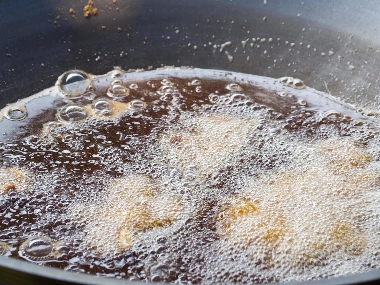 Boiling oil in frying pan for cooking photo