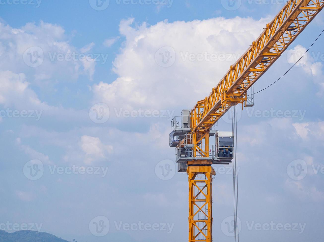 Construction site with crane on blue sky background photo