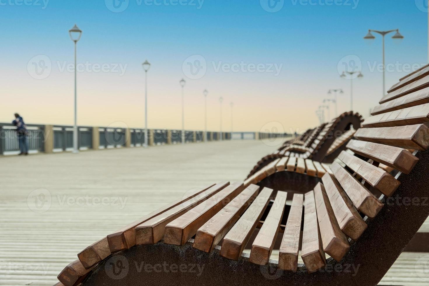 Sun loungers on an empty sea promenade photo