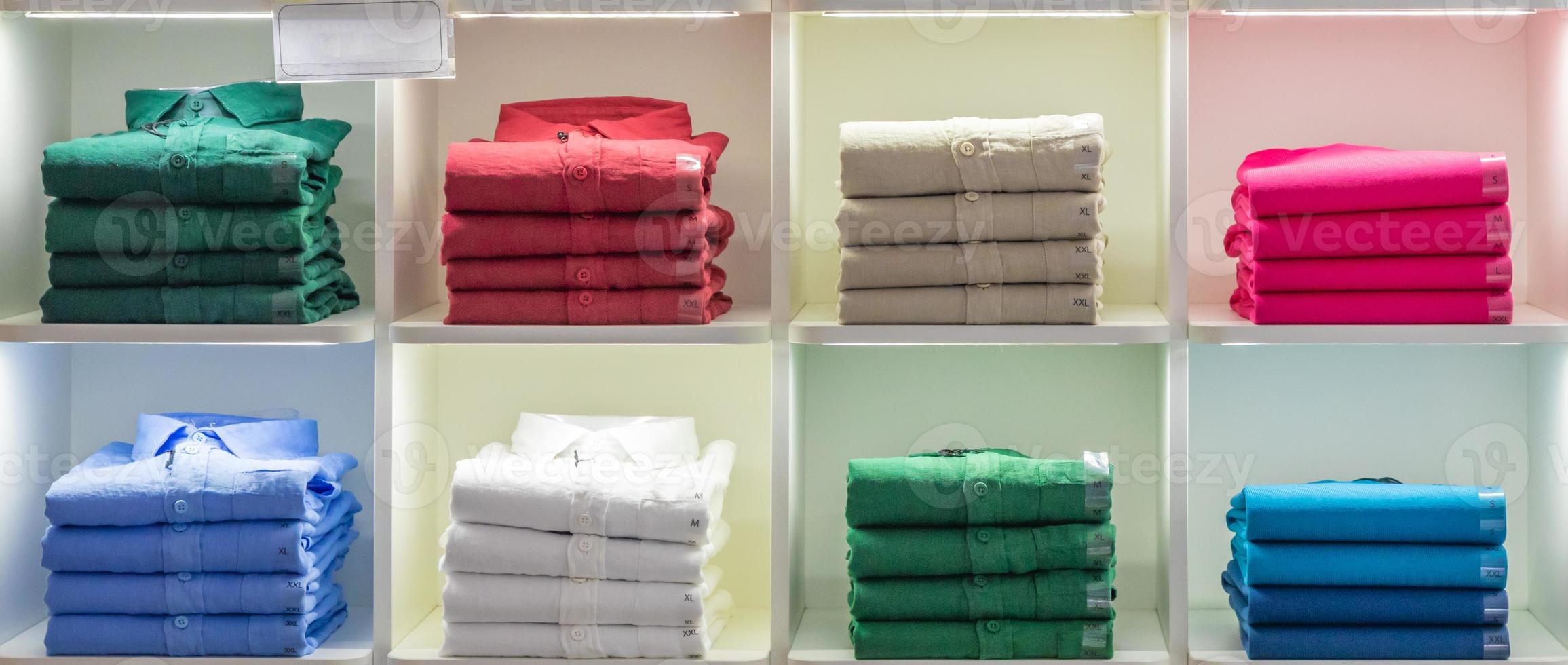 Polo t-shirt store interior. Shop shelves with  colored fashion cotton shirt photo