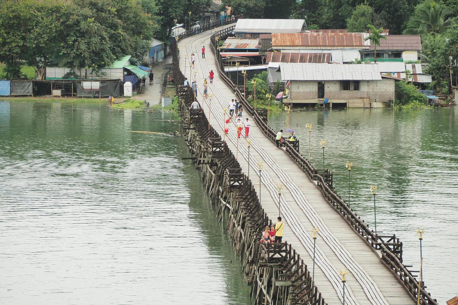 The Mon Bridge, Kanchanaburi,Thailand-July 8'2020 -the image of Tourists walking on the Mon Bridge photo