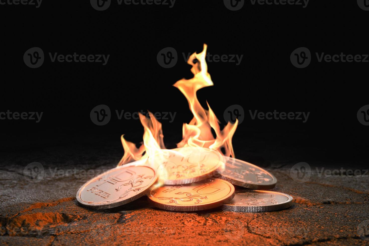 Russian Ruble coins burning on black background. Concept loss of value and inflation. 3d render photo