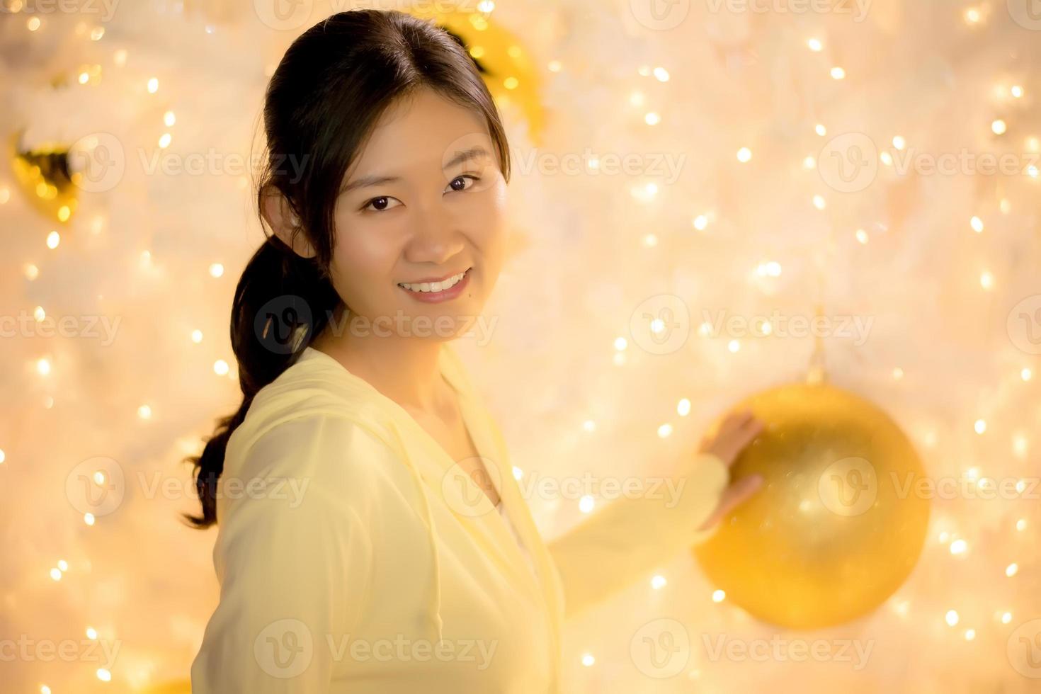 Woman catch Xmas ball and led on rainbow new year background. photo