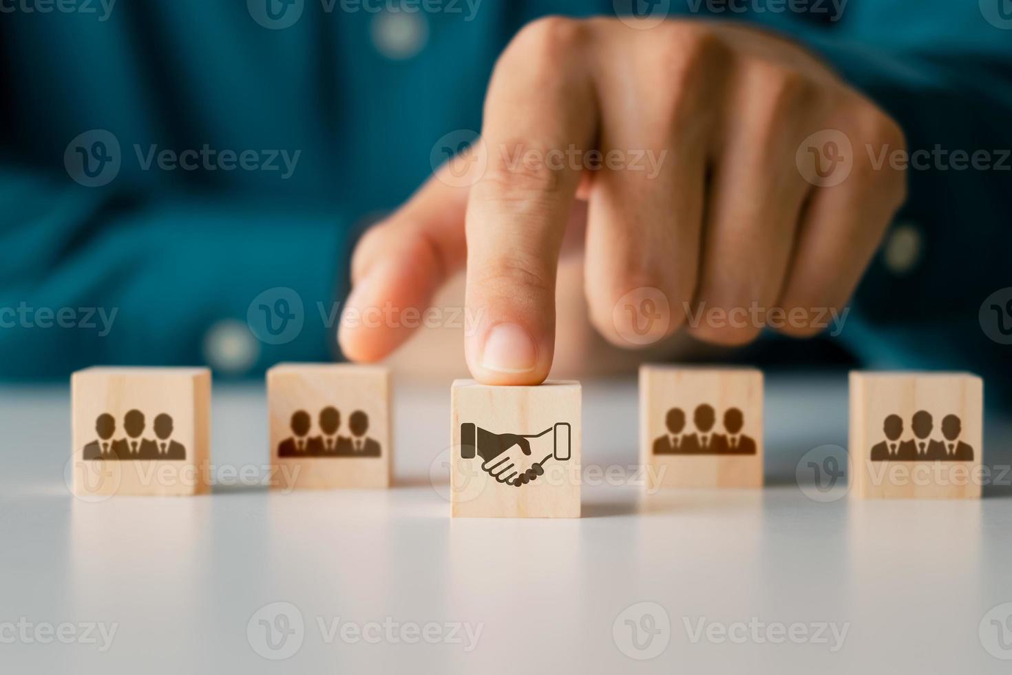 Business Agreement Ideas, Wooden Cube Blocks Businessman icon shaking hands, business cooperation. photo