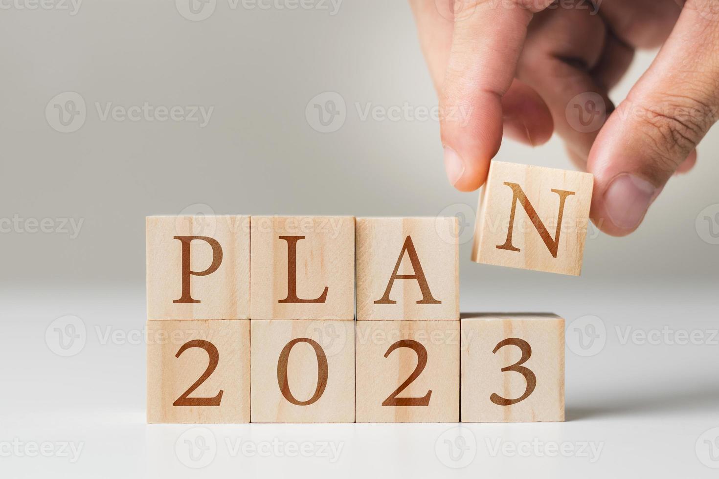 2023 new year goal planning idea, wood block cube with new year 2023 and target icon, business vision. photo