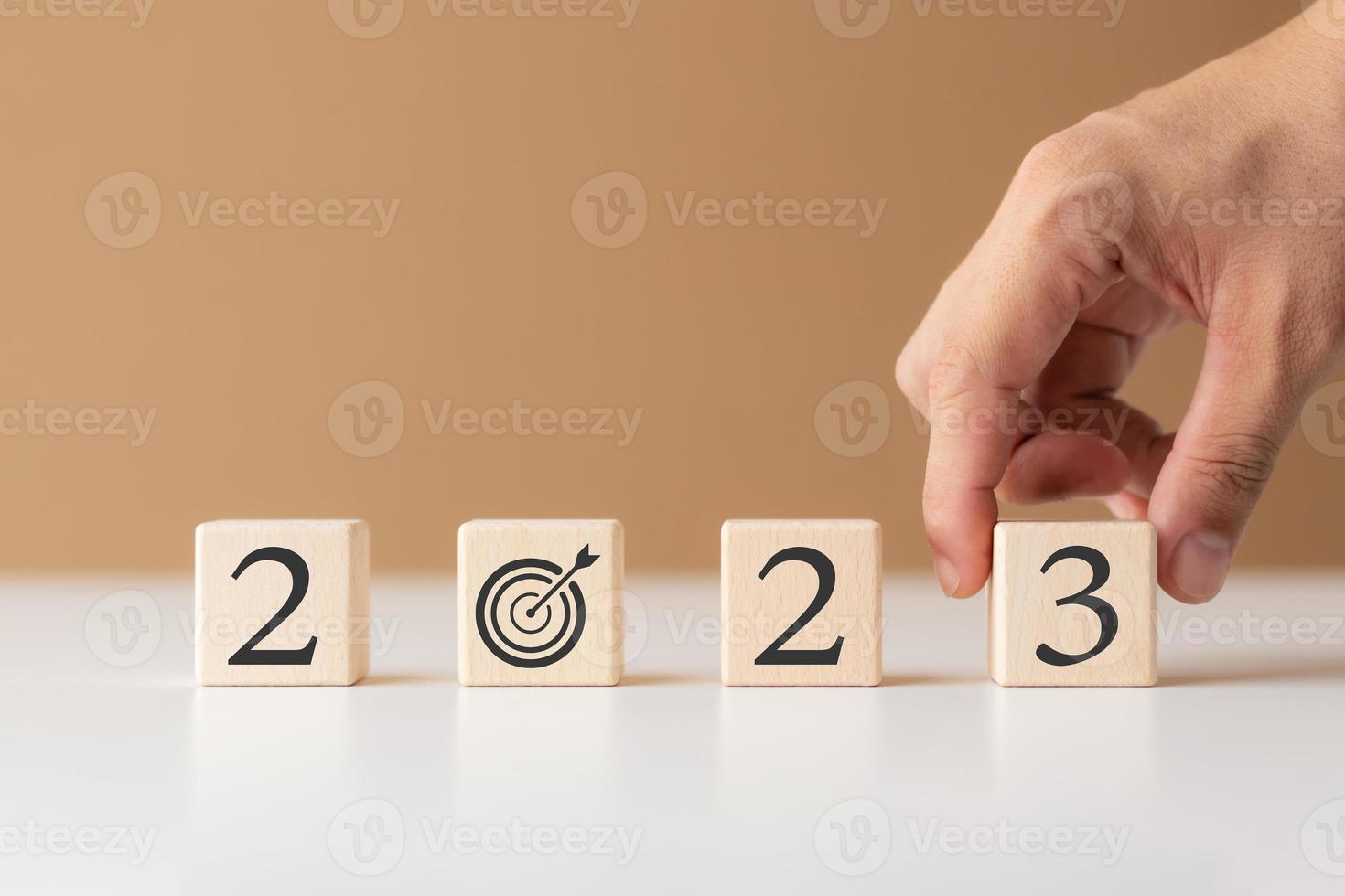 2023 new year goal planning idea, wood block cube with new year 2023 and target icon, business vision. photo