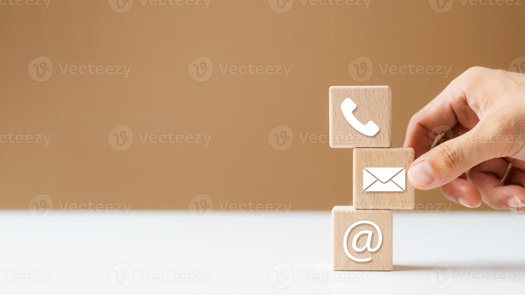 Hand putting wood blocks Cube Symbol Phone, Email, Address. contact or email marketing concept. photo