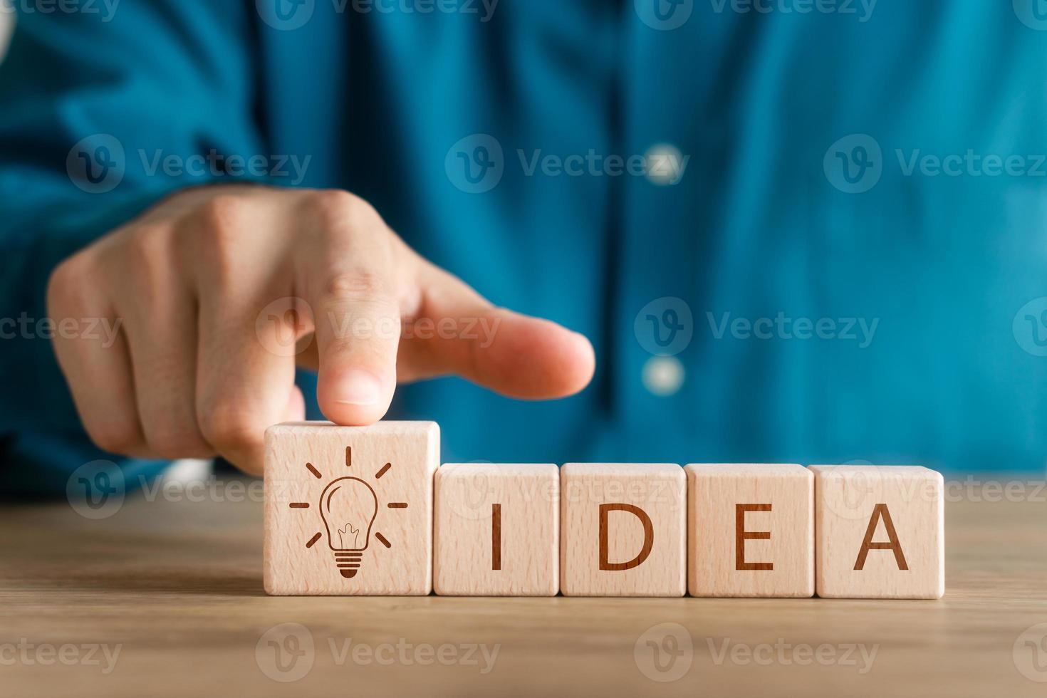 Wooden cube block with icon light bulb, word ideas, innovation through ideas and inspiration. Creative thinking. photo