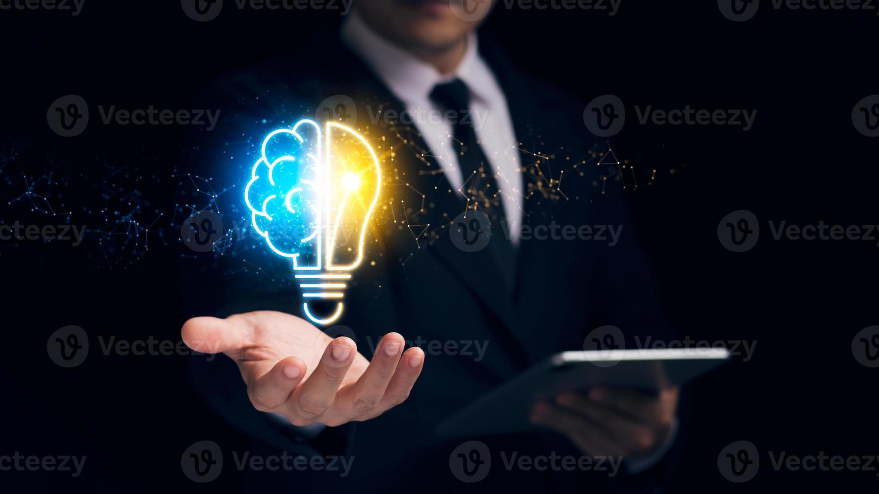 Businessman holding a virtual bulb and half-brain, innovation through ideas and ideas that inspire smart thinking. photo