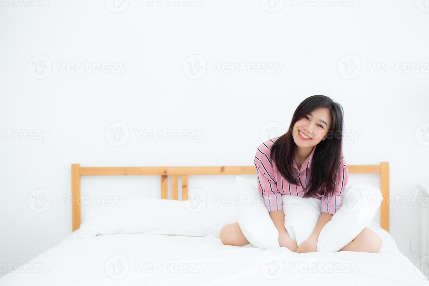 Beautiful portrait young asian woman lying and smile while wake up with sunrise at morning, lifestyle and relax concept. photo