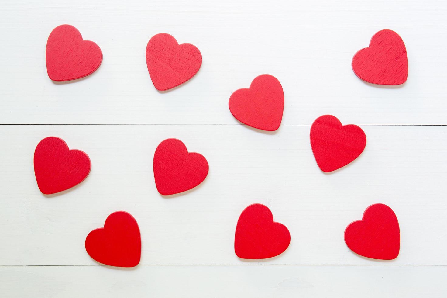 Red Heart texture pattern with love on wooden background, 14 February Valentine day on grunge white wood, celebration and holiday concept, top view, copy space. photo