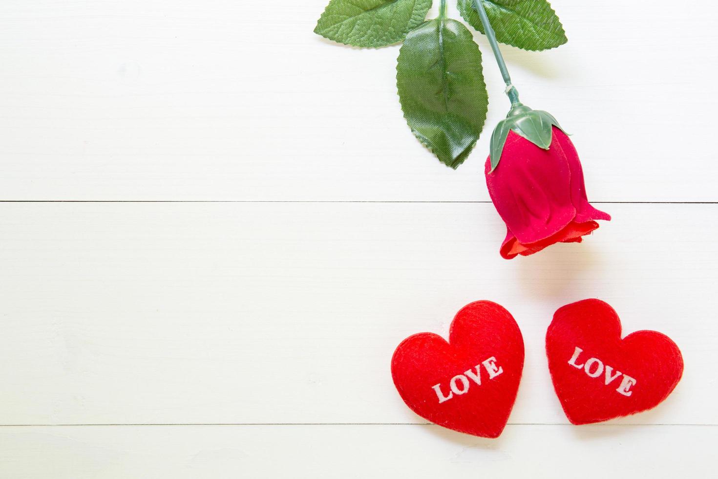 Present gift with red rose flower and heart shape on wooden table, 14 February of love day with romantic copy space, valentine holiday concept, top view. photo