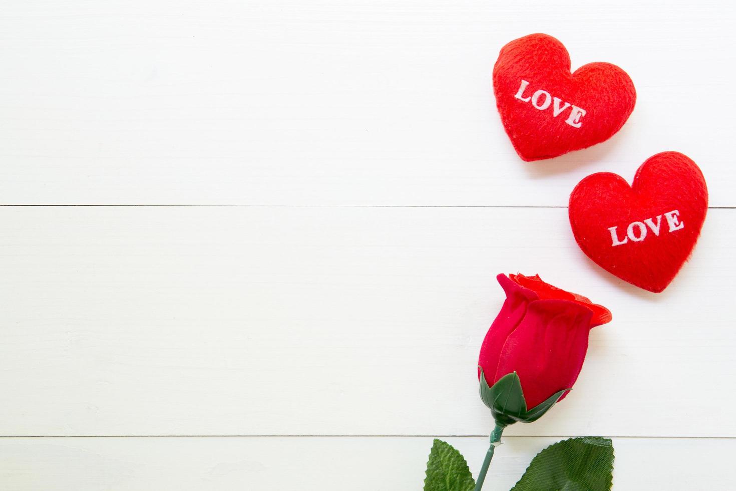 Present gift with red rose flower and heart shape on wooden table, 14 February of love day with romantic copy space, valentine holiday concept, top view. photo