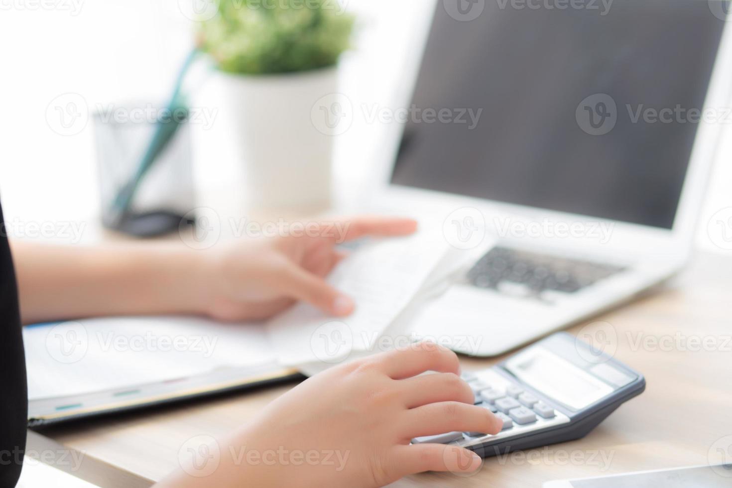 closeup hand woman calculating expenses household and writing notebook on desk, girl checking bill and stress and note, female worry debt and tax, finance and business concept. photo