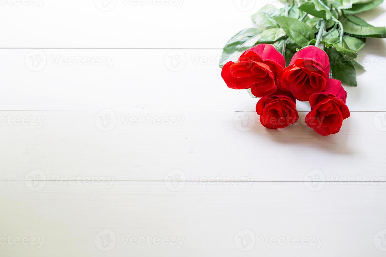 Present gift with red rose flower on wooden table, 14 February of love day with romantic, valentine holiday concept. photo