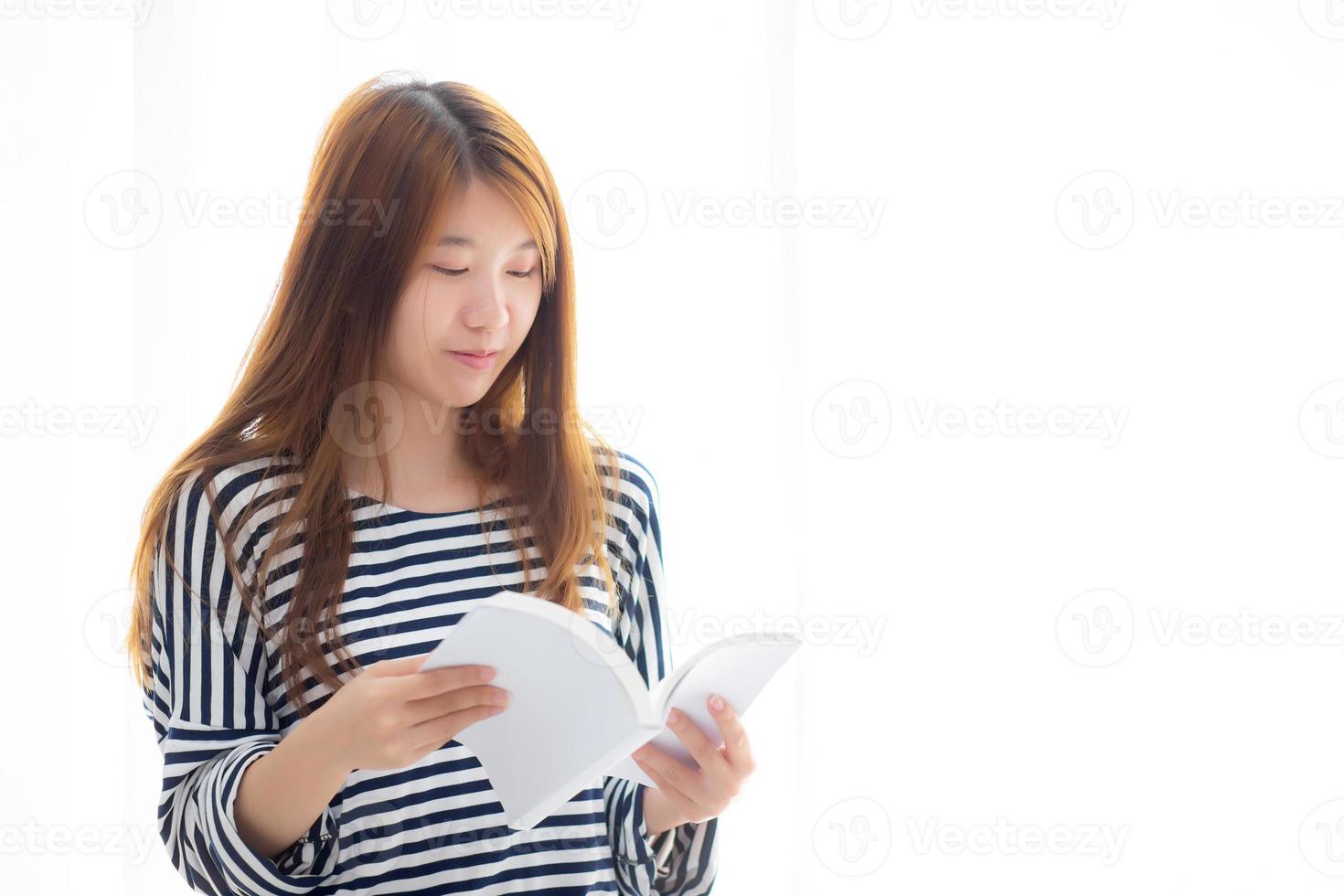 Beautiful of portrait young asian woman relax standing reading book on bedroom at home, girl study literature, education and lifestyle concept. photo