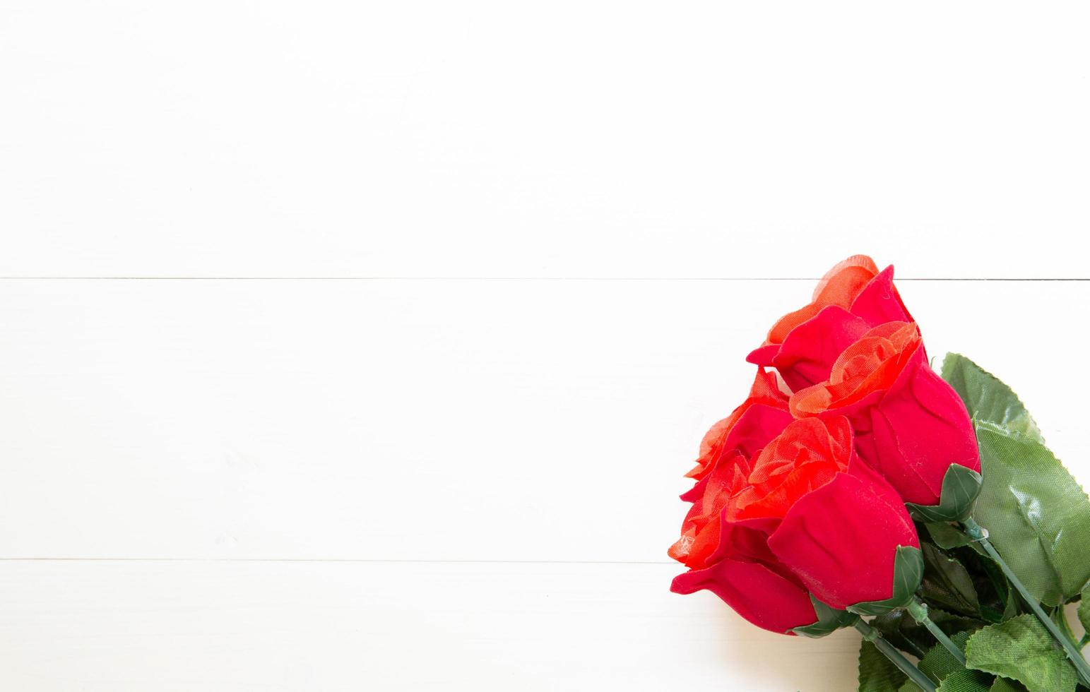 Present gift with red rose flower on wooden table, 14 February of love day with romantic copy space, valentine holiday concept, top view. photo