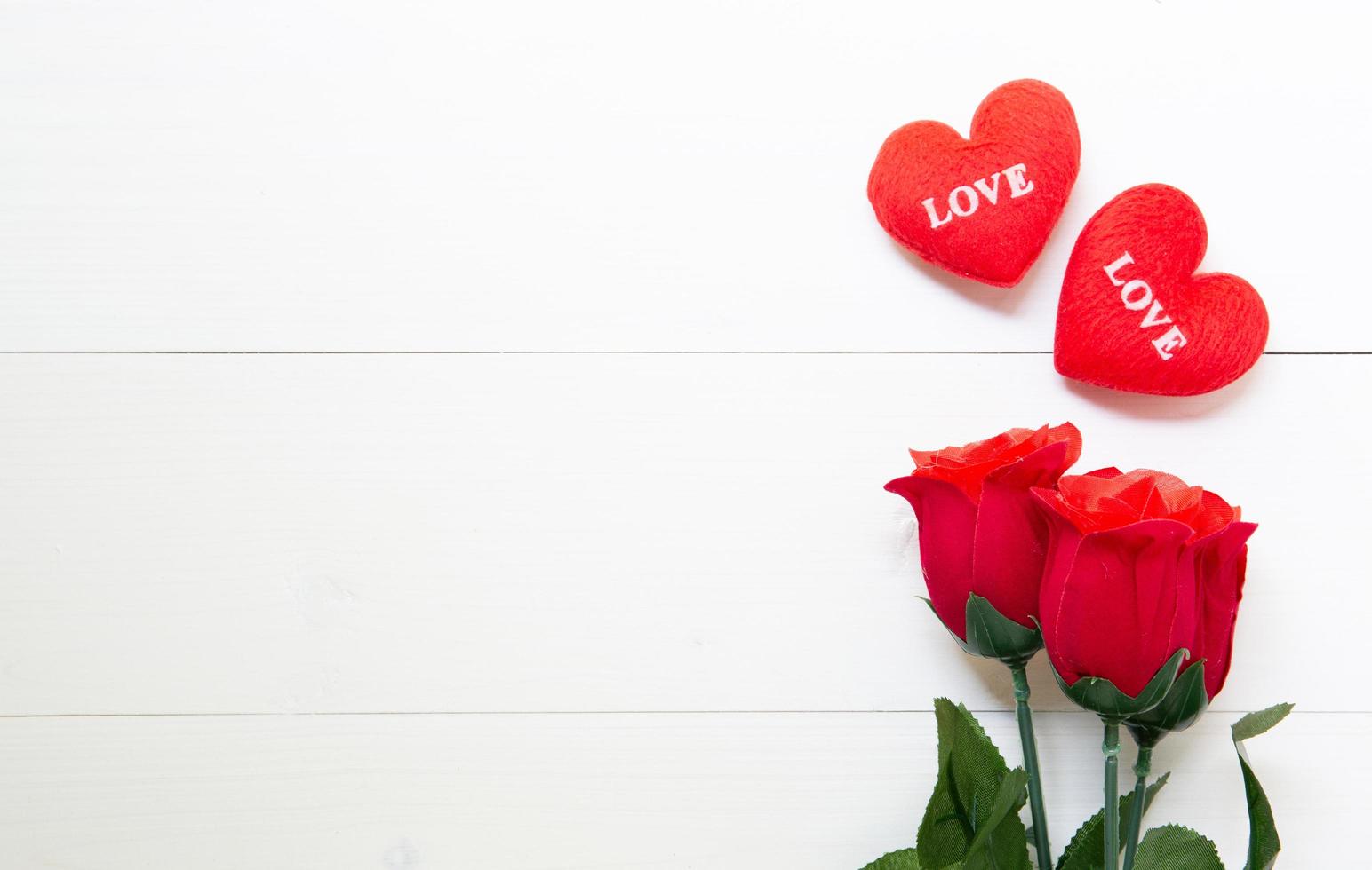 Present gift with red rose flower and heart shape on wooden table, 14 February of love day with romantic copy space, valentine holiday concept, top view. photo