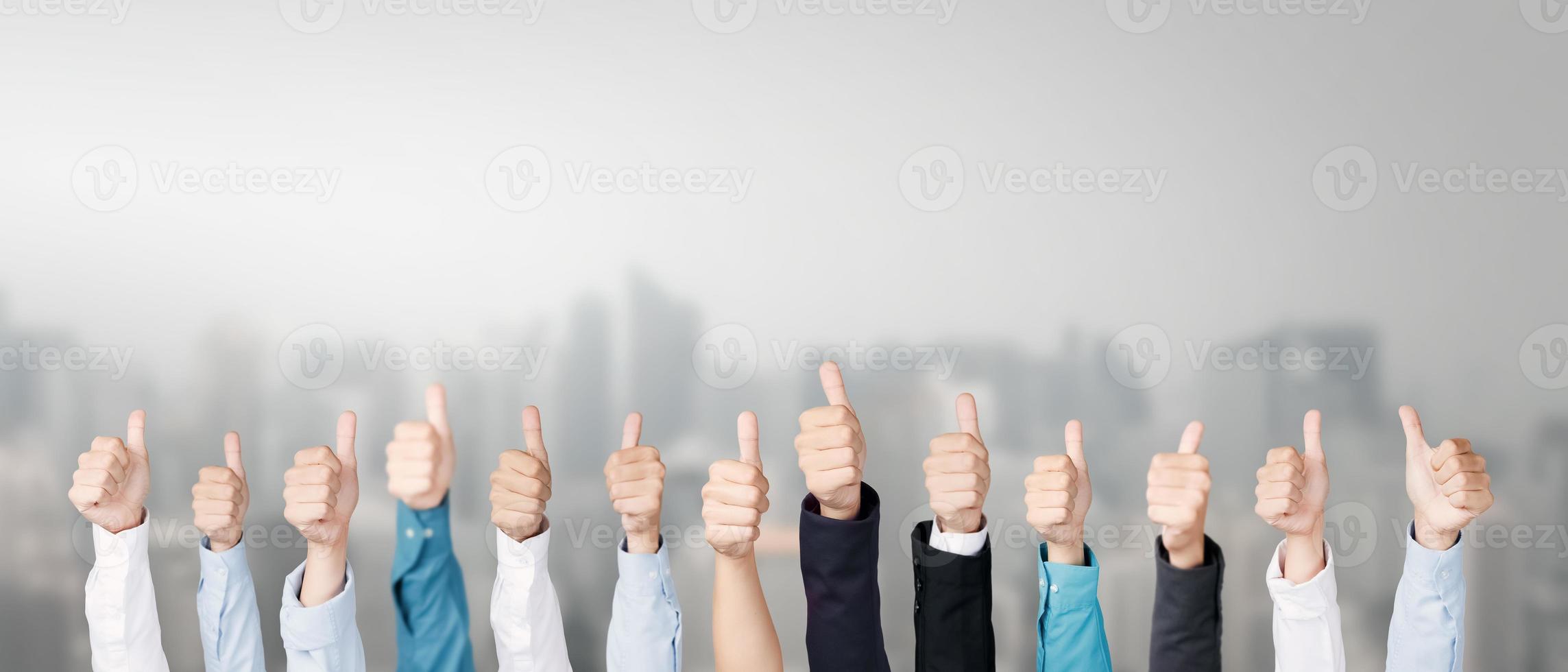 Business team showing thumbs up and symbol of excellence, showing success. photo