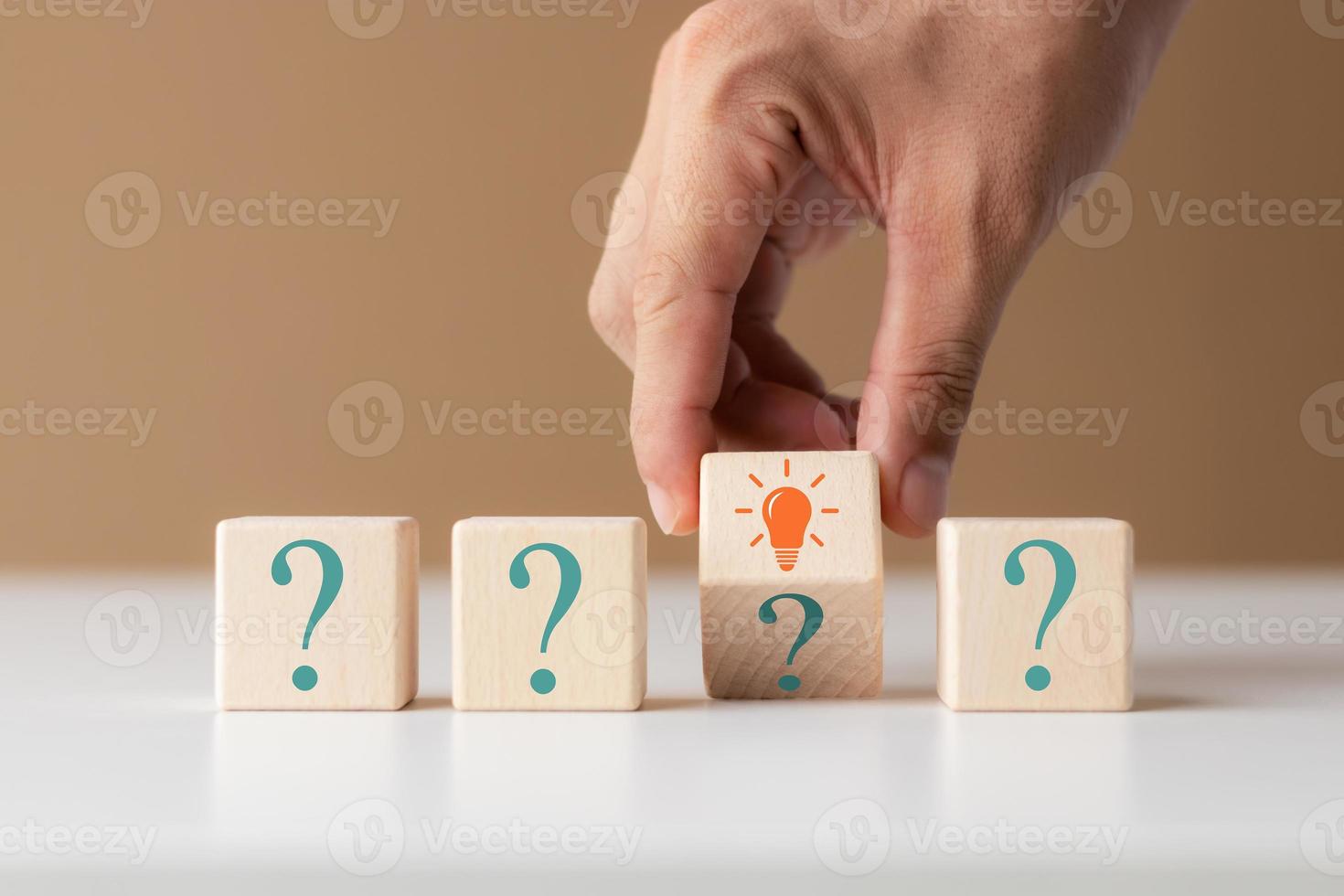 Creative concept. Think different, wooden cube with question mark and light bulb sign. photo