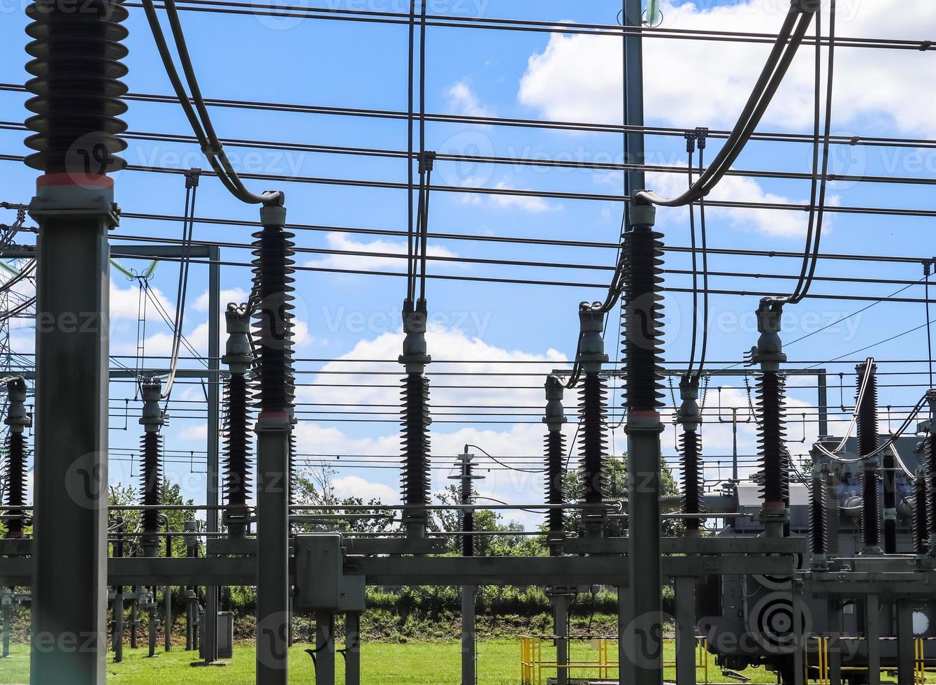 Electrical Transformer. Distribution of electric energy at a big substation with lots power lines on a sunny day photo