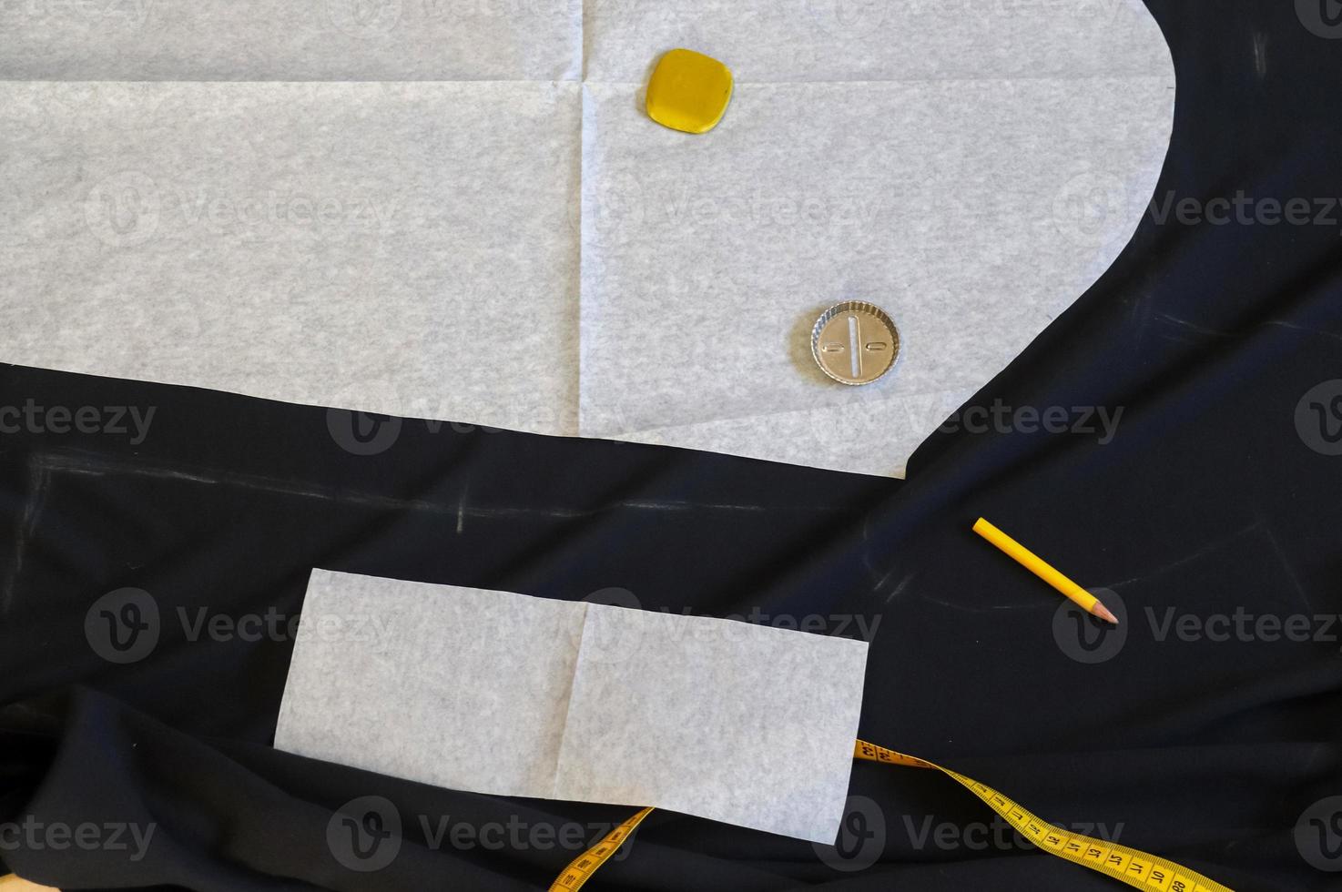 Sewing concept. Different sewing accessoires on a black fabric background. photo