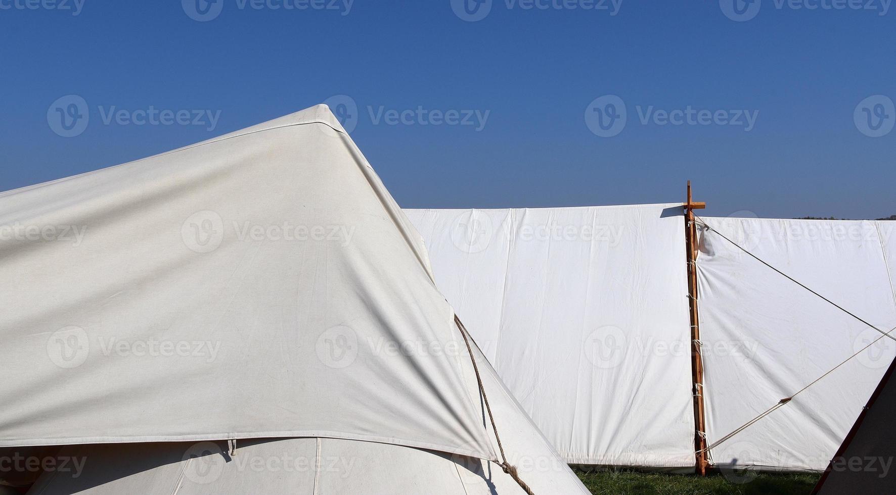 Old vikings tent made of wood and cloth in front of a blue sky photo