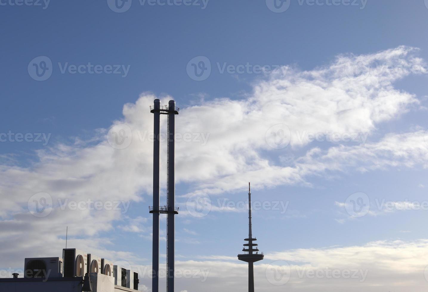 Industry pollution from factory smoestacks in a deep blue sky photo