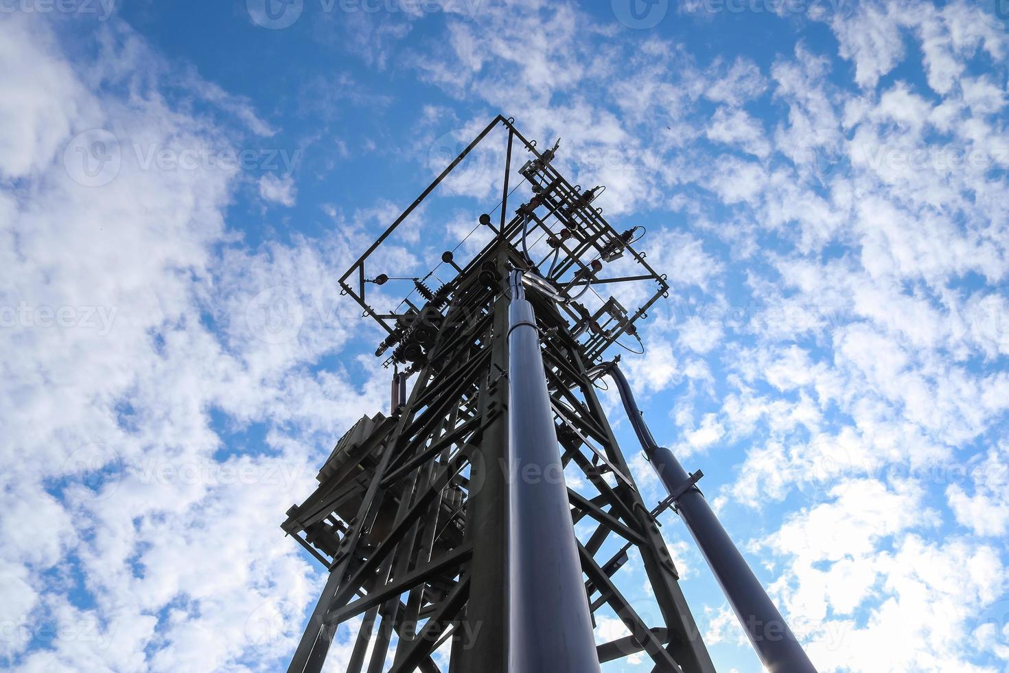 Close up view on a big power pylon transporting electricity in a countryside area photo