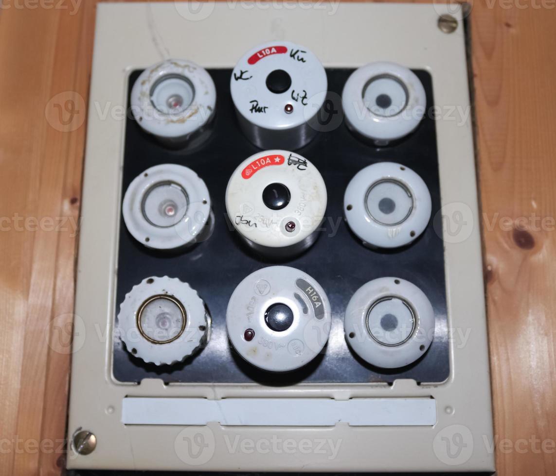 Old fuse box with ceramic fuses and some handwritings on it. photo