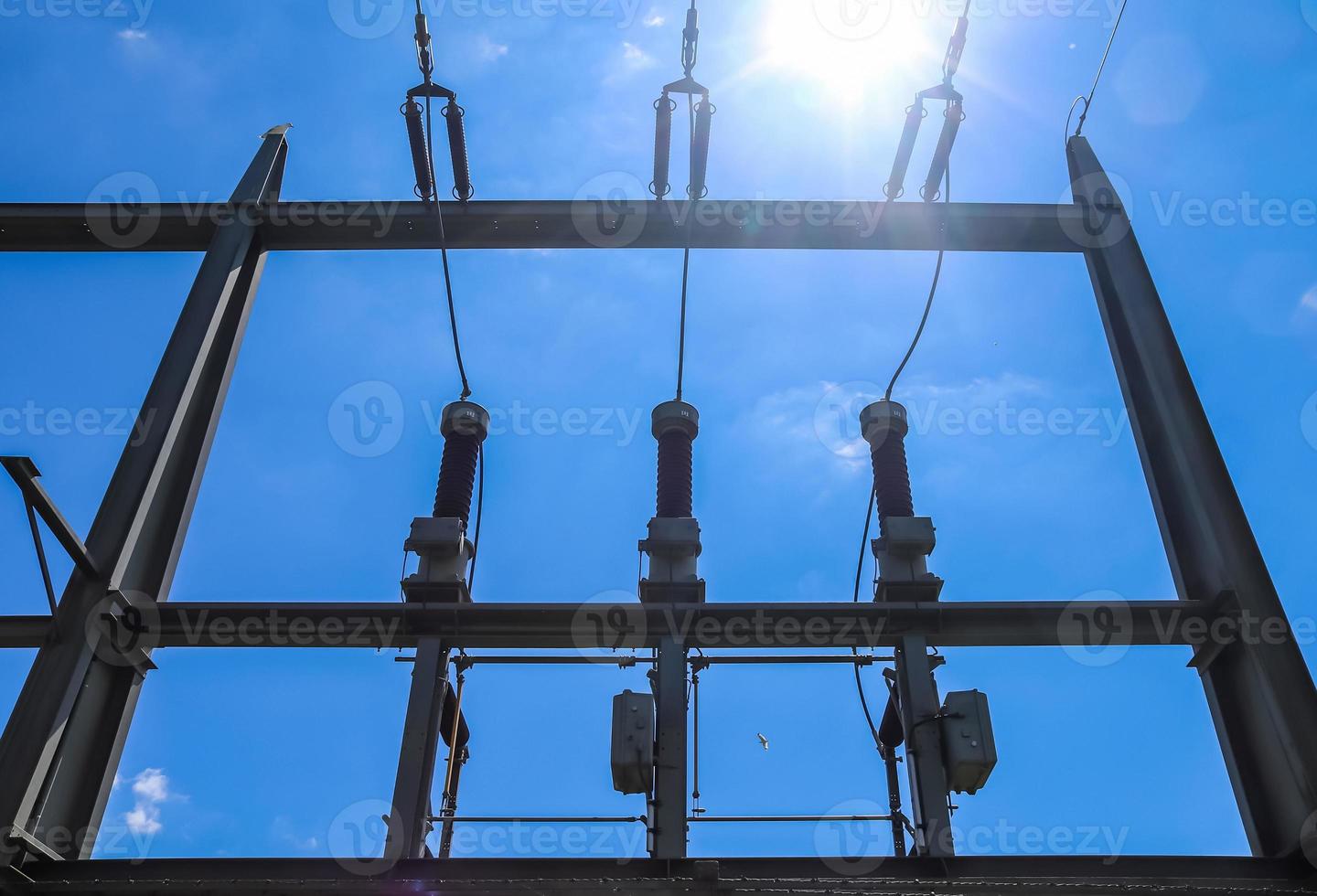 Electrical Transformer. Distribution of electric energy at a big substation with lots power lines on a sunny day photo