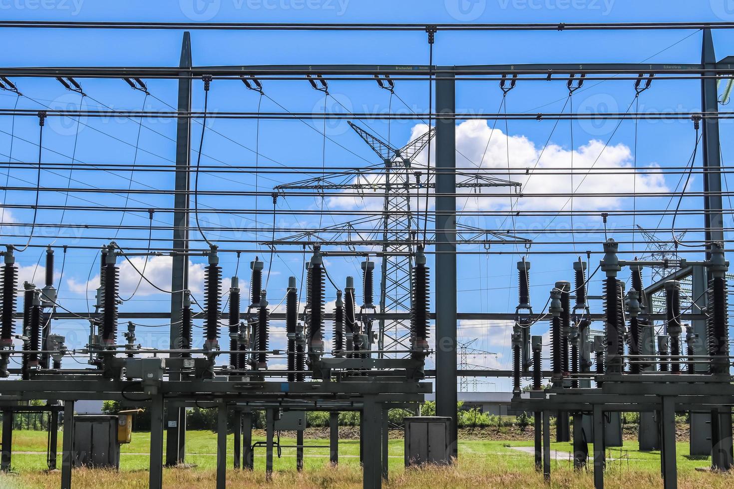 Electrical Transformer. Distribution of electric energy at a big substation with lots power lines on a sunny day photo