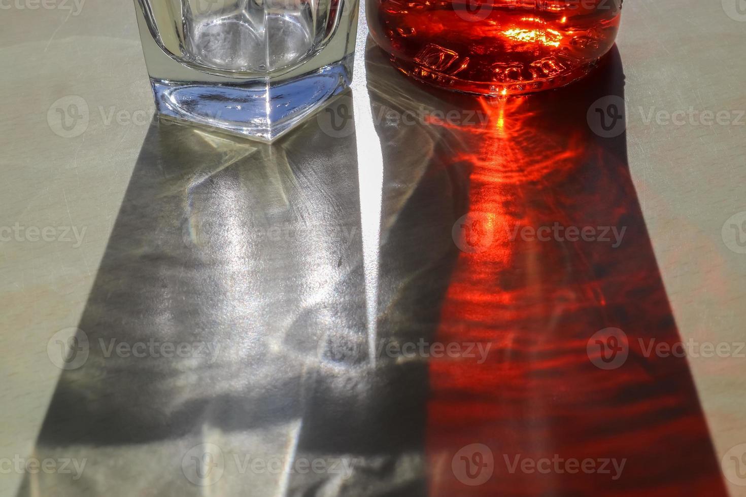 Sunlight shining through a drinking glas showing caustic light effects. photo