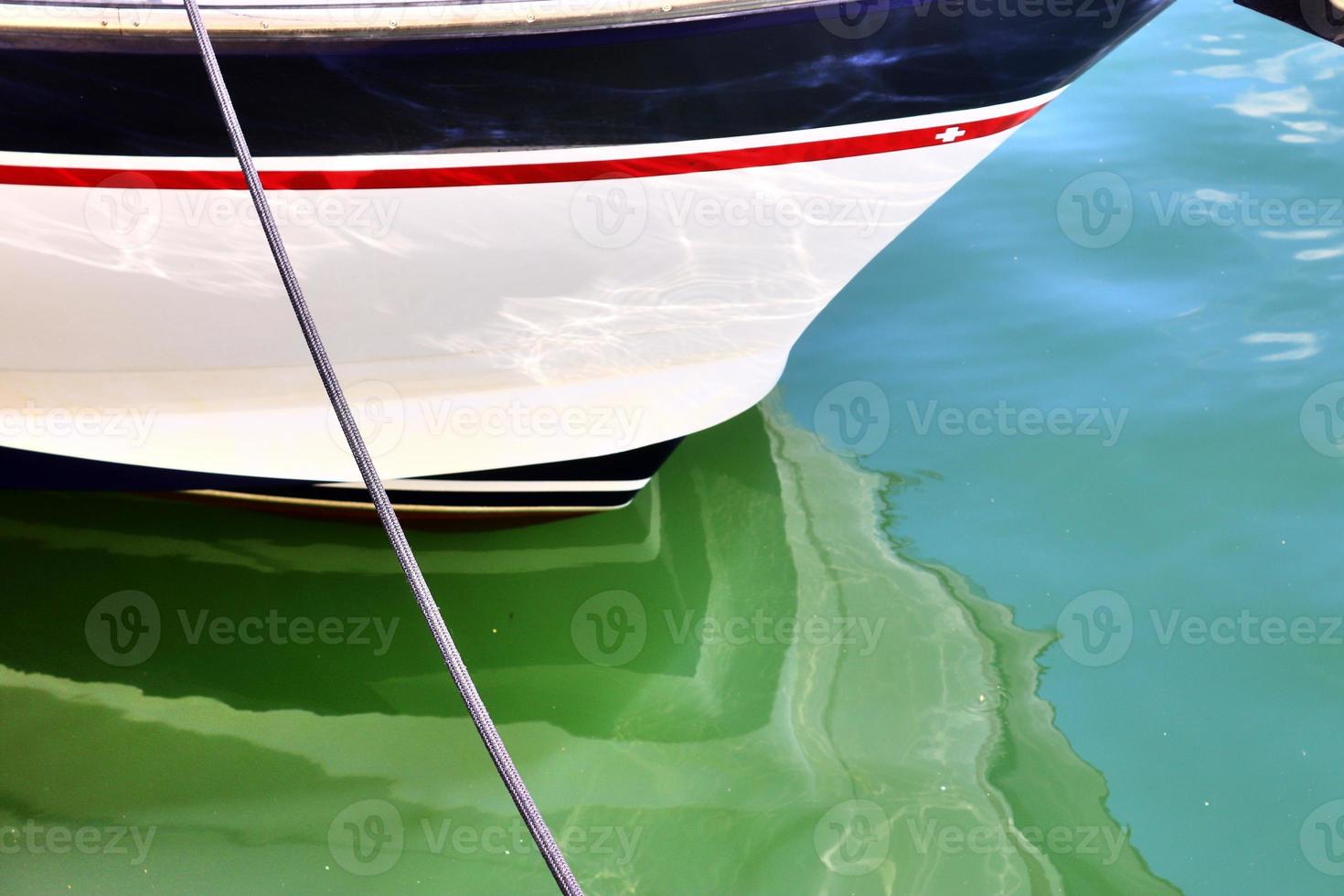 Sailing ship mast against the blue sky on some sailing boats with rigging details. photo