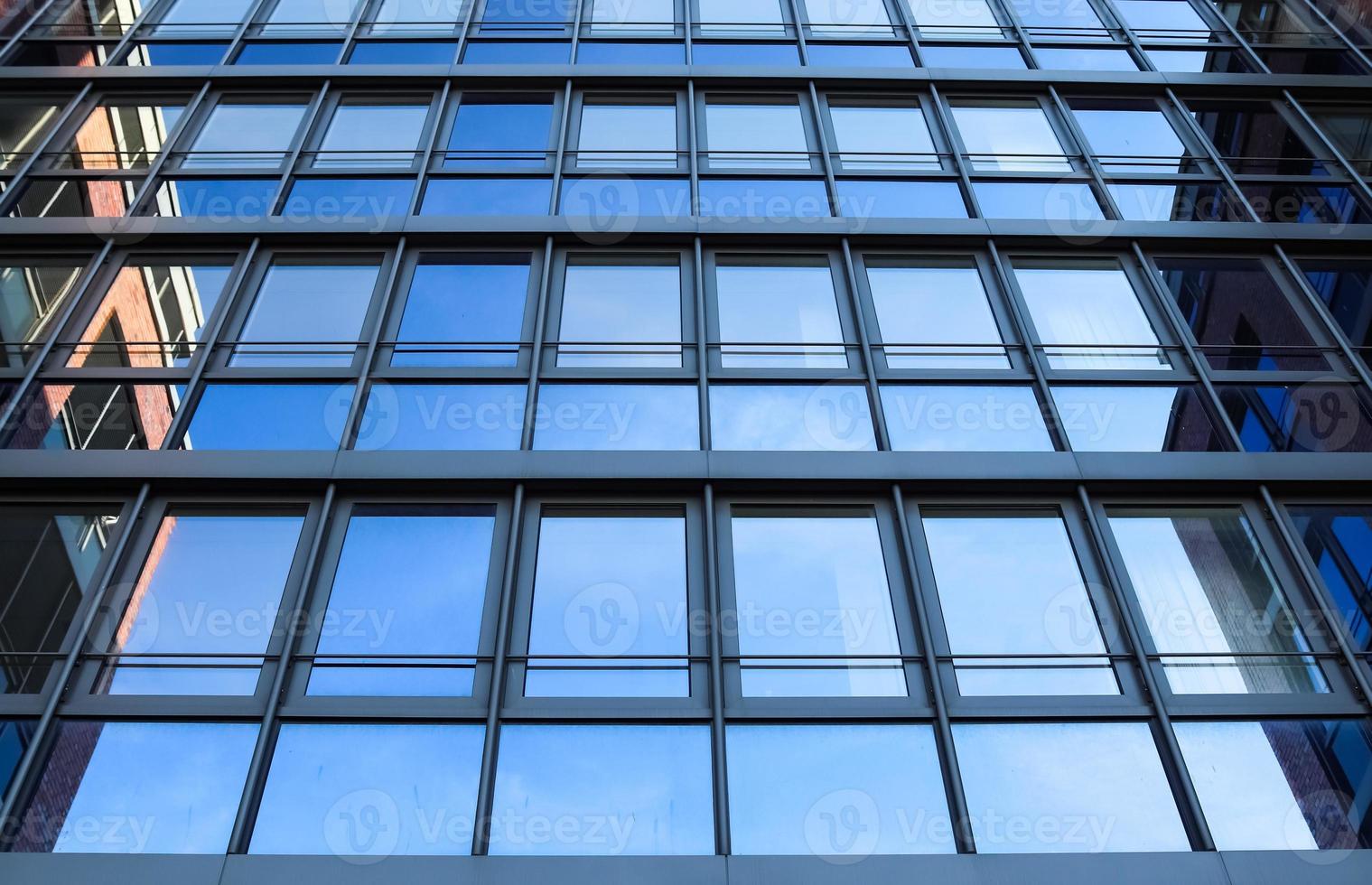 Modern office building facades with glass and reflecting sunlight in the windows photo