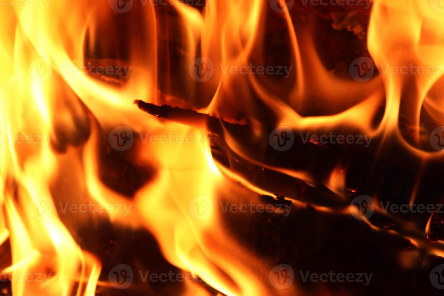 Beautiful red and orange hot burning fire in a fireplace photo