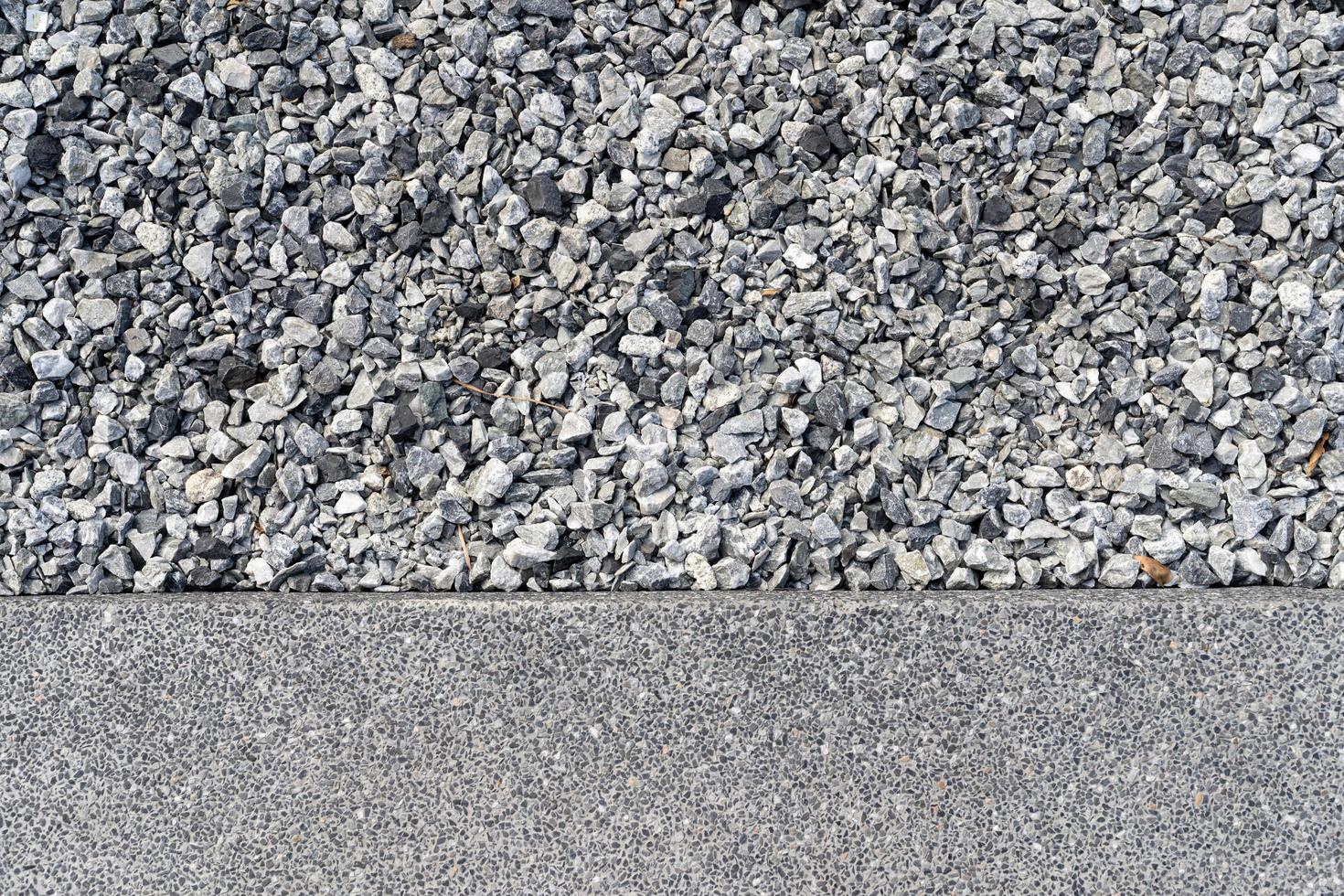 Rock stone pebble and ground dirt walkway path. Small gray stones, lots of grey rocks on the ground photo