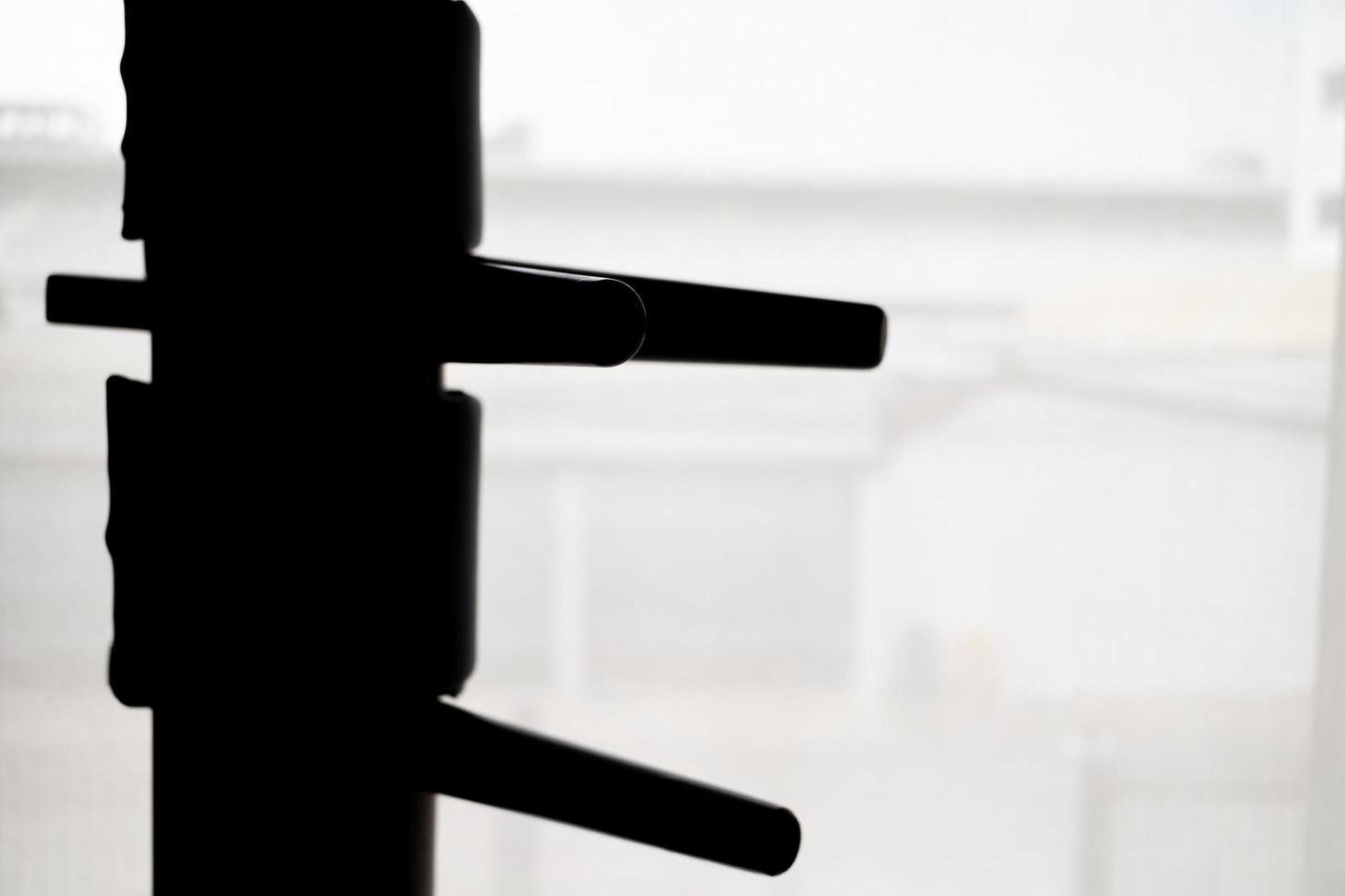 Silhouette of wooden dummy on a background. Wing Chun Kung Fu Self defense photo
