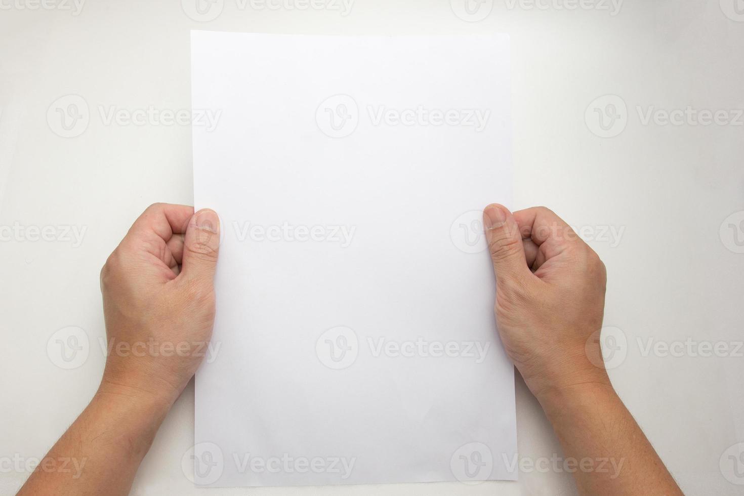 The concept of both hands that holding a white sheet a4 of paper blank photo