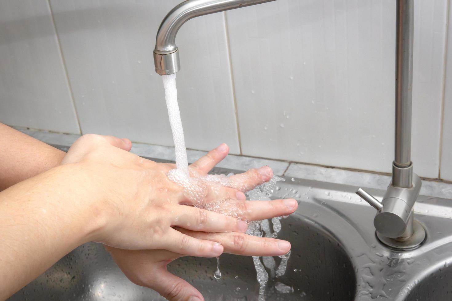 Both hands are washing their hands in the sink.Hygiene concept. photo