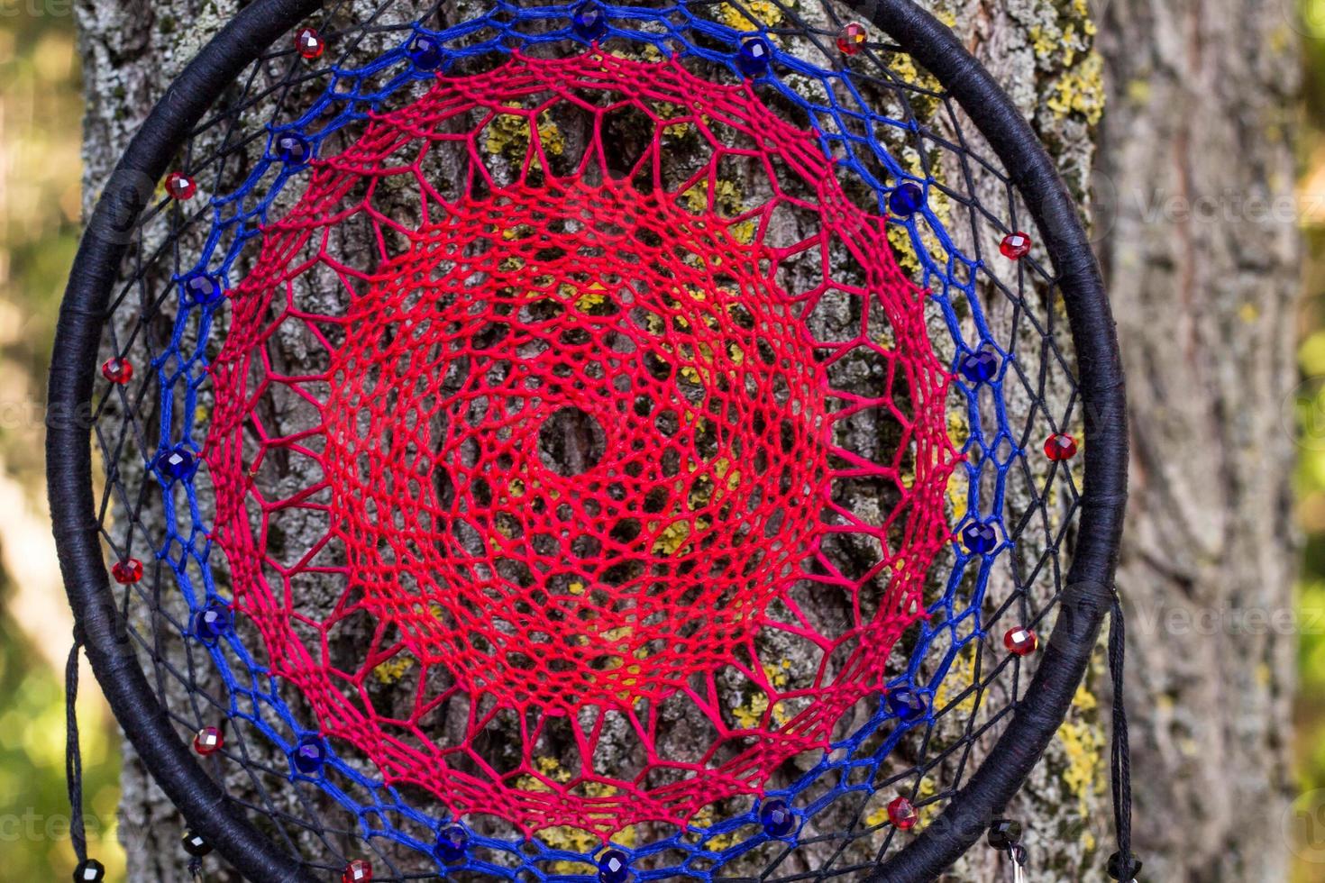Handmade dream catcher with feathers threads and beads rope hanging photo