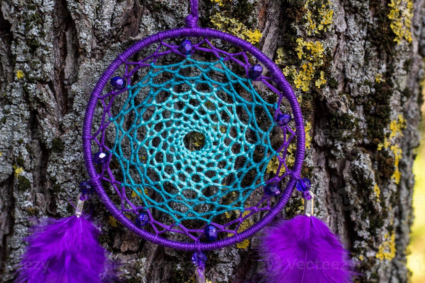 Handmade dream catcher with feathers threads and beads rope hanging photo