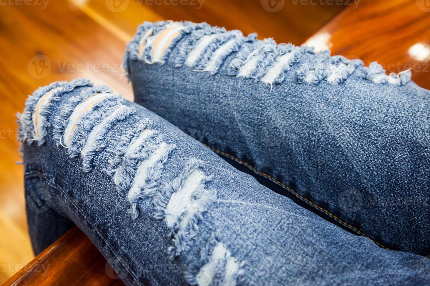 leg of women in fragmentary and torn jeans photo