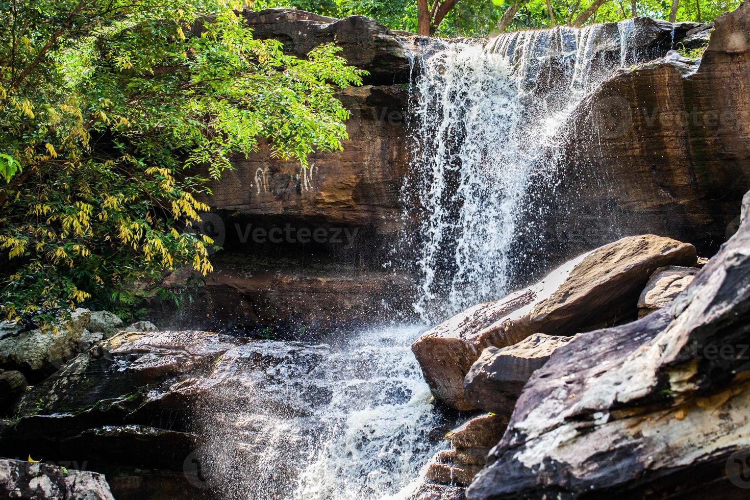 Tropical waterfall in rain forest photo