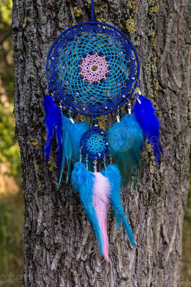 Handmade dream catcher with feathers threads and beads rope hanging photo
