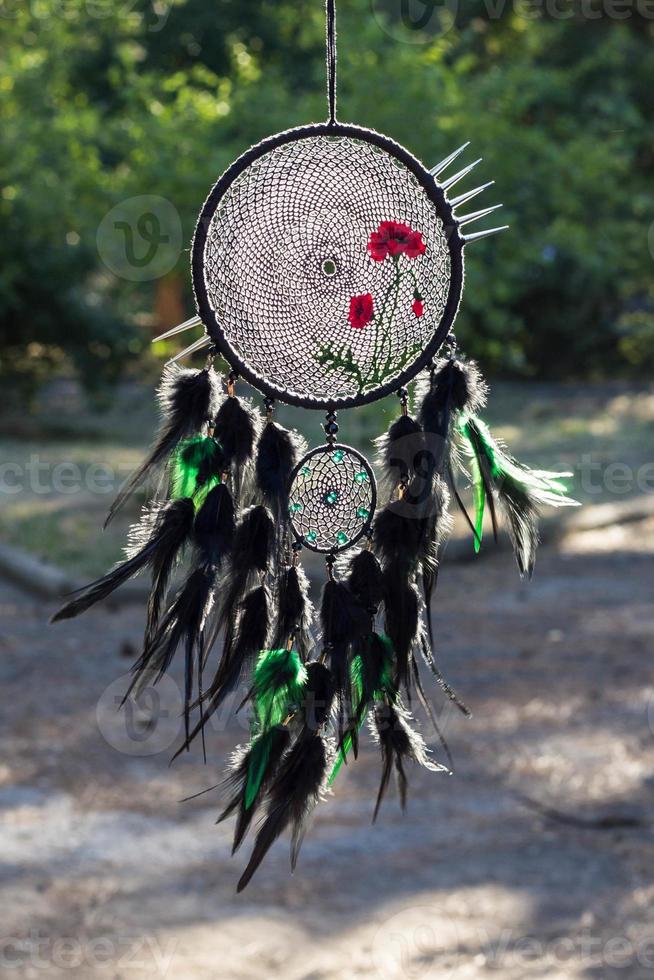 Handmade dream catcher with feathers threads and beads rope hanging photo