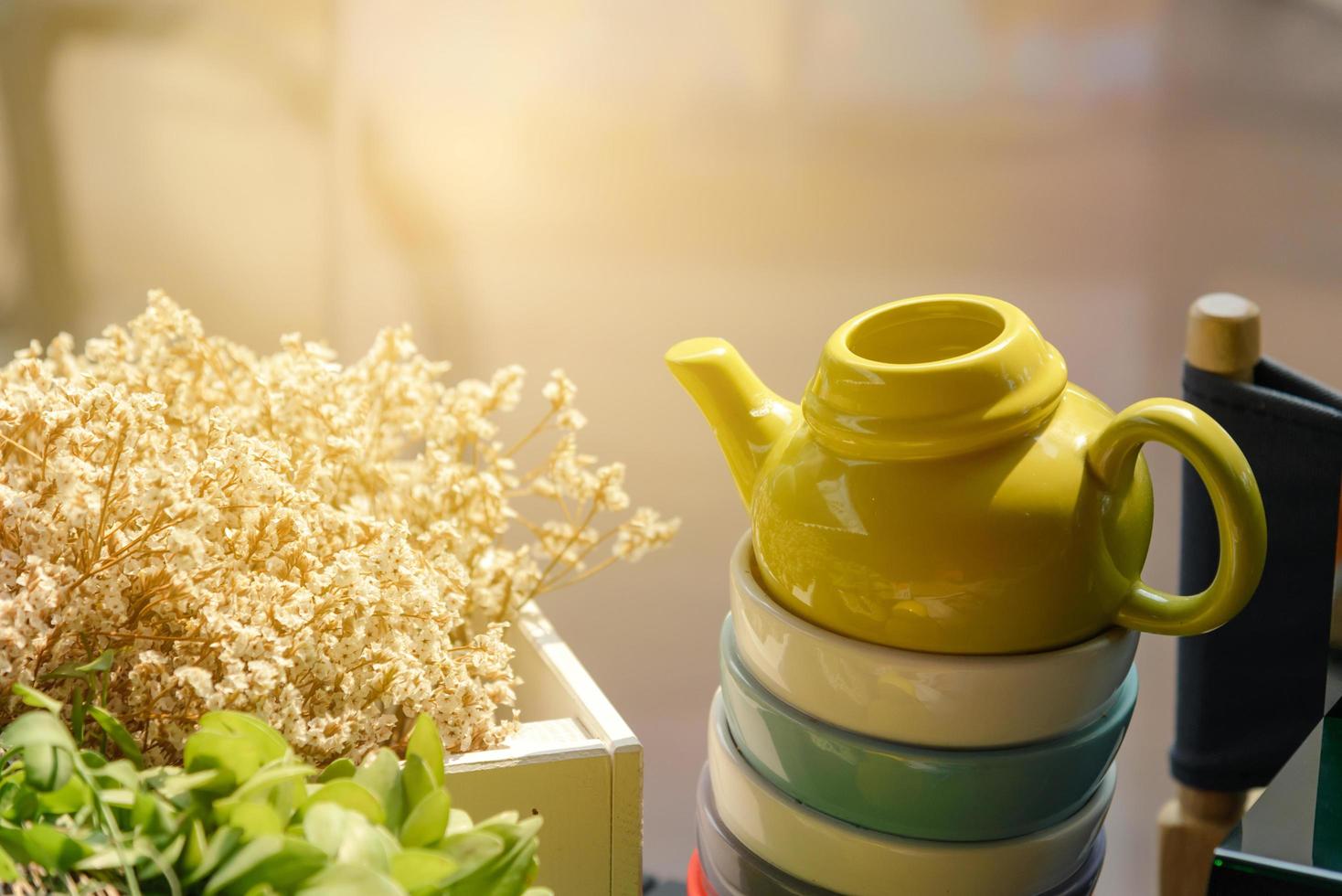 ceramic teapot on ceramic teacup with sunlight on the morning photo