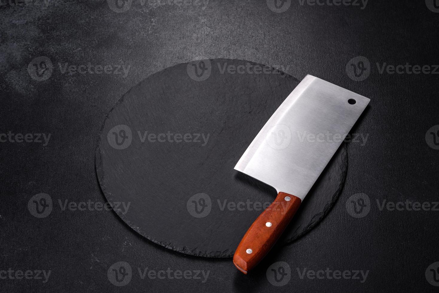 Black plate on a black background. Flat lay, top view, copy space photo