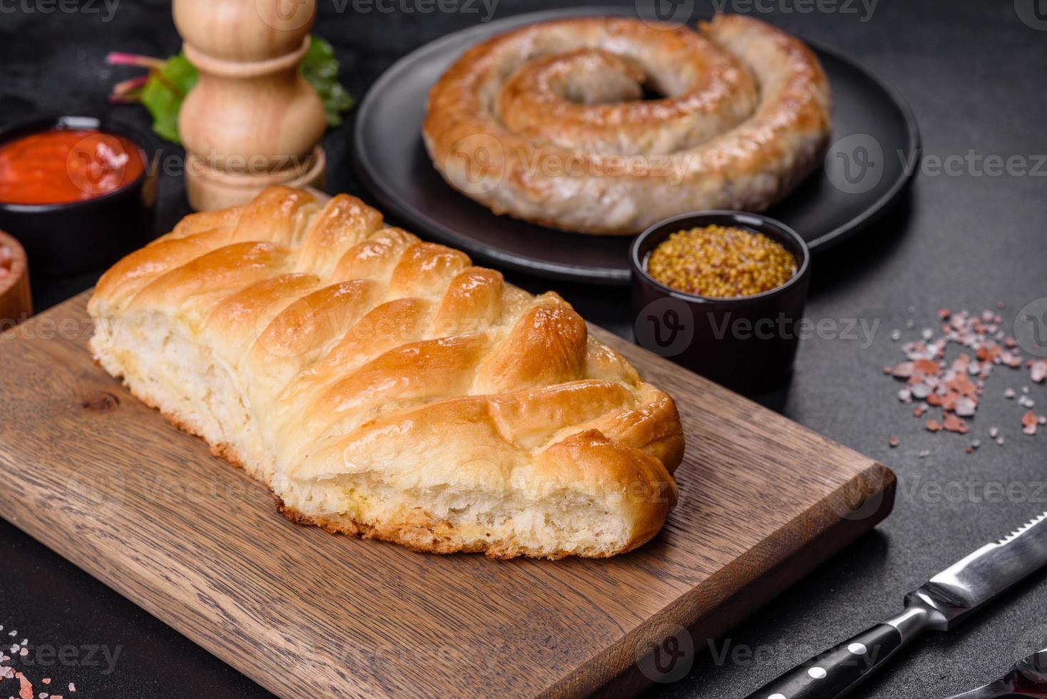 Traditional Ukrainian cabbage pie on a dark concrete background. Baked homemade pie with cabbage photo